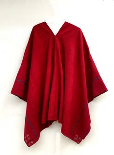 "Measures 160cm. x 160cm. \"We traveled through the southern Peruvian Andes\" Looking for vintage fashion, exclusive to the time, that preserves its original color and designs. It is almost impossible to find an exactly the same textile because it is 100% handmade. It is a very nice red poncho worked with natural dyes from the area, with blue lines, very warm, worked with sheep's wool, this work is handmade from the time. This poncho was made in a house in the close center of southern Peru. You Traditional Red One-size Poncho, Bohemian Wool Poncho In Cape Style, Bohemian Wool Poncho Cape, Red One-size Cape Shawl, Traditional Red Poncho For Fall, Traditional Winter Poncho, Traditional Red Shawl Poncho, Traditional Red Fall Poncho, Traditional Handmade Winter Cape