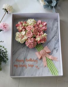 a birthday card in a box with flowers