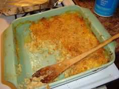 a casserole dish is sitting on the stove with a wooden spoon in it