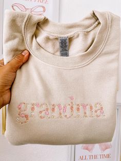 This Grandma Sweatshirt is Tan in color and features floral embroidery designed with intricate flowers. For all the mimis out there. This sweatshirt makes a perfect gift.  TAN COLOR T-SHIRT & SWEATSHIRT only  SHIPPING estimate is between 7-10 business days. HEART SLEEVE INFORMATION- THERE IS A LISTING FOR HEART SLEEVES IN OUR SHOP We only add up to 5 hearts in ONE sleeve Any additional hearts they will be a charge of $3 dollars for each heart  (if you need additional hearts, please message me) P Grandma Christmas Gift Ideas, Grandma Embroidered Sweatshirt, Shirt Ideas For Grandma, Gifts For Your Grandma, Grandma Gift Ideas, Grammy Sweatshirt, Gift For New Grandma, Gift Ideas For Grandma, Mimi Gifts