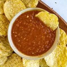 a bowl of salsa with tortilla chips on the side