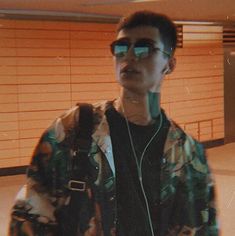 a young man wearing headphones in an airport