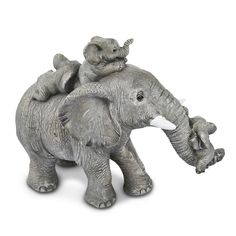 an elephant figurine with two baby elephants on its back