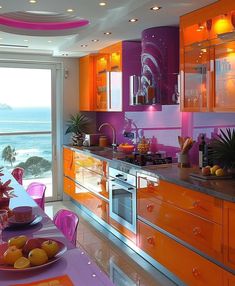 an orange and pink kitchen with the ocean in the backgrounnd, is shown