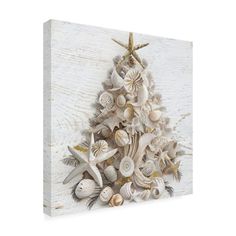 a christmas tree made out of seashells and starfish on a white wooden background