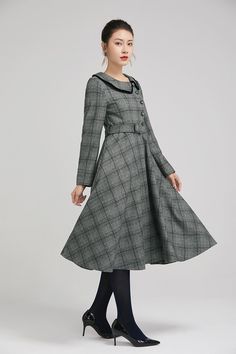 "Simple. With its pleated skirt and grayscale plaid pattern, this vintage wool dress epitomizes classic styling. She's all class and quality with no bells or whistles. Near-perfect vintage condition, designed with lapel collar, long sleeves and tie belt waist, it will be your favorite one of your wardrobe. Details: * 35% wool blend, 35% fiber and polyester, 30% nylon * Polyester lining * long sleeves * tie belt waist * lapel collar * button decoration in front * knee length * back zipper closure Classic Fitted Plaid Dress For Fall, Classic Fall Vintage Dress For Workwear, Classic Vintage Dress For Fall Workwear, Classic Vintage Dress For Work In Fall, Vintage Plaid Dress For Winter, Vintage Plaid Winter Dress, Classic Vintage Fashion Dresses For Fall, Retro Plaid Winter Dresses, Winter Plaid Long Sleeve Dress