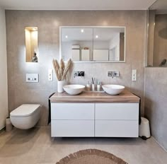 a modern bathroom with two sinks and a toilet in it's own area,