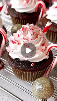 cupcakes with white frosting and candy canes