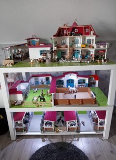 a doll house with horses and people inside