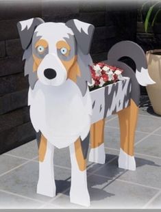 a paper cut out of a dog with flowers in it's mouth