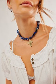 A bold finishing touch to any outfit, this choker features natural-cut stone beads with a shining metal cross pendant. **Features:** Choker style, beaded design, natural-cut stones, hammered metal cross pendant, adjustable clasp closure **Why We | Supernova Choker by Free People in Blue Bohemian Blue Beaded Choker Necklace, Bohemian Blue Choker Jewelry, Adjustable Handmade Blue Choker, Blue Bohemian Choker, Unique Adjustable Blue Choker, Free People Necklace, Mykonos Blue, Free People Jewelry, Blue Choker