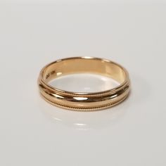 Thanks for shopping our vintage estate store. We tend to sell well below wholesale and truly hope you enjoy all of our items. Many of the items are one of a kind, so please enjoy scrolling through the pictures and hopefully something will catch your eye. Brown spots are from the camera or reflections. Estate 10k yellow gold 4mm wide band with detailed edge. Ring size: 5.5 or 7 Width: 4mm Weight: 2.15 grams 7 Weight: 1.76 grams 5.5 Marked 10k and it's a nice wide band. Gold Milgrain Round Band, Gold Milgrain Bands For Anniversary, Heirloom Milgrain Bands For Anniversary, Classic Yellow Gold Bands With Milgrain, Classic Yellow Gold Milgrain Bands, Classic Gold Wedding Ring With Milgrain Detail, Round Milgrain Bands For Anniversary, Gold Milgrain Jewelry For Wedding, Heirloom Yellow Gold Milgrain Rings