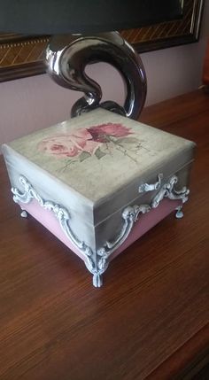 a decorative box sitting on top of a wooden table