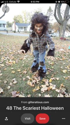 a person dressed as a monkey in the grass with leaves on it's feet