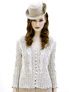 a woman wearing a white hat and sweater