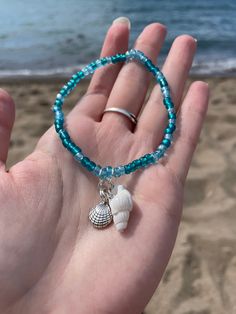 A very beach seashell bracelet set with turquoise colored beads. The set includes two turquoise beaded bracelets with seashell charms! Bracelet 1: Silver starfish charm and silver clam shell charm Bracelet 2: White seashell charm and silver seashell charm A perfect bracelet set for beach lovers! Cheap Beaded Bracelets With Heart Beads For Beach, Bracelet Beach Summer, Beachy Charm Bracelet, Beach Beads Bracelets, Sea Shells Bracelet, Shell Charm Bracelet, Turquoise Ocean-inspired Bracelet With Starfish Charm, Ocean-inspired Turquoise Bracelet With Starfish Charm, Turquoise Beaded Bracelets With Starfish Charm