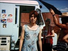 a woman standing in front of a food truck