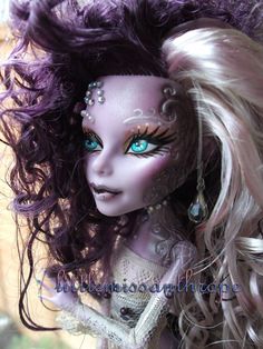 a close up of a doll with purple hair and blue eyeliners on her face