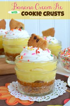 three desserts in small glass jars with sprinkles and decorations on top