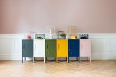 a row of lockers sitting next to each other on top of a hard wood floor