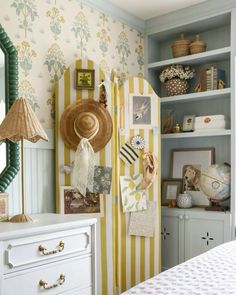 a bedroom with yellow and white striped walls