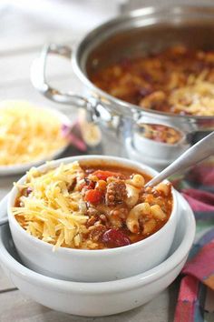 one pot chili mac and cheese soup in a white bowl with a spoon on the side