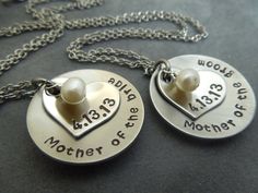 two personalized necklaces with hearts and names attached to each other on a chain