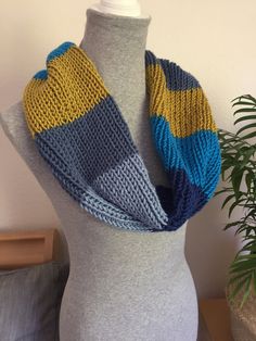 Beautifully soft infinity scarf in shades of blue and a stripe of chartreuse -  hand knit with yarn made of acrylic, nylon and merino wool. Incredibly lush feel and will keep the chill off on those cold, windy days! Machine wash and dry. Winter Hand Knitted Acrylic Infinity Scarf, Blue Knitted Yarn Scarf, Handmade Blue Casual Scarves, Blue Knitted Yarn Scarves, Casual Handmade Blue Scarves, Blue Hand Knitted Scarf, Handmade Blue Yarn Scarves, Hand Knitted Yarn Infinity Scarf, One Size, Handmade Blue Yarn Scarf