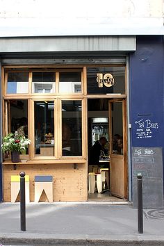 a store front with flowers in the window