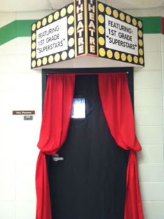 a theater marquee with red curtains and black door