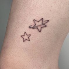 two stars on the side of a woman's stomach, one is black and white