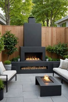 an outdoor fireplace with two couches and a fire pit in the middle of it