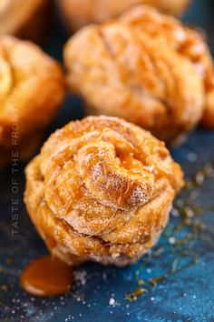 several pastries are stacked on top of each other with caramel sauce drizzled around them