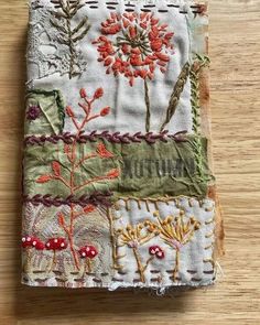 a piece of fabric with flowers and plants on it