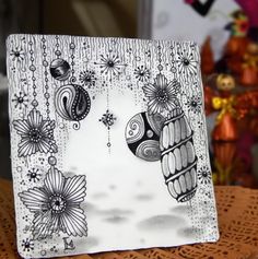 a card with an image of a bird and flowers in the background on a table