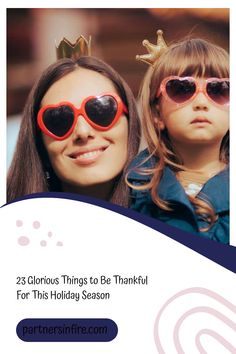 Mother and daughter wearing heart-shaped sunglasses and crowns, smiling together.