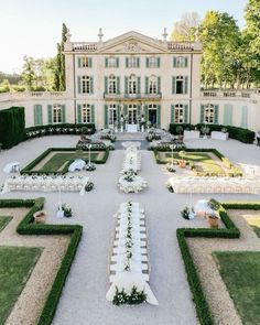 an outdoor wedding venue with white tables and chairs set up in front of the building