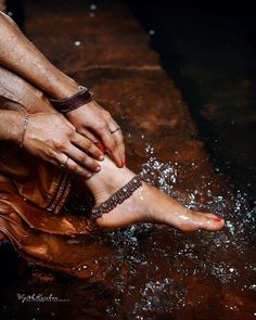 a woman's feet are covered in water