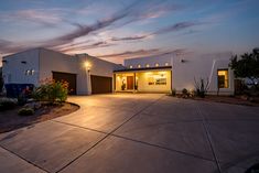 a house with lights on in the driveway