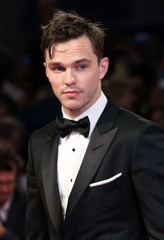 a young man in a tuxedo and bow tie at the venice film festival