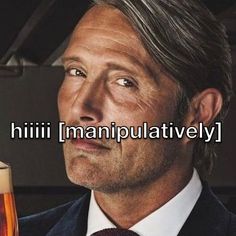 a man in a suit and tie holding a glass of beer with the caption'hili i mampulatively '