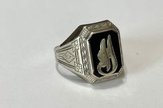 "Timeless antique 1940s era 14k white gold genuine onyx letter \"H\" ring! The classic statement ring has a 14k white gold setting that contains a genuine black onyx gemstone. In the center of the onyx is an old English letter \"H\" . A fantastic piece of fine vintage genuine gem ring!  ERA - Circa 1940s /Late Art Deco-Early Retro  METAL / MATERIAL - 14k white gold, genuine onyx MARKINGS / HISTORY - Inside of band is marked \"14k\"   CONDITION - Good vintage condition. Gold metal has been polished & cleaned. Age appropriate patina & wear remains. Genuine onyx is secure.  Amazing antique letter \"H\" signet ring!  SIZE / MEASUREMENTS - Size: 10 1/2, Ring Head Height: 18.3 mm, Rise Of Ring Off Finger: 4.9 mm, Shank: 3.3 mm, Weight: 5.10 grams https://www.etsy.com/shop/LastCenturyJewels" Vintage White Gold Initial Ring Stamped 14k, Vintage Silver Initial Ring In 14k Gold, Vintage White Gold Initial Ring In 14k, Vintage 14k White Gold Initial Ring, Vintage Initial Ring In 14k Gold And Silver, Vintage White Gold Initial Ring For Anniversary, Vintage Silver Signet Ring In 14k Gold, Vintage Sterling Silver Signet Ring For Formal Events, Vintage Sterling Silver Signet Ring For Formal Occasions