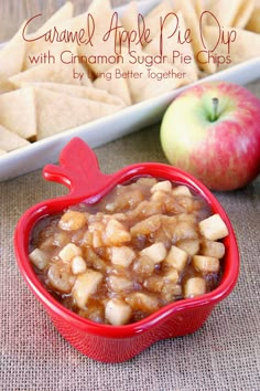 an apple pie dip with cinnamon sugar pre - chips in a red bowl next to apples