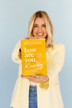 a woman holding up a book in front of her face with the title how are you really reading?