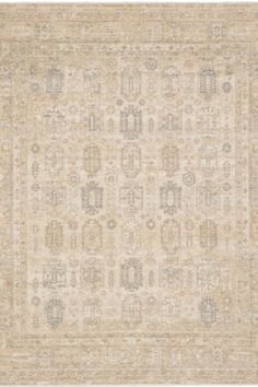 an antique rug with many different colors and patterns on the carpet, in neutral tones