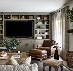 a living room filled with furniture and a flat screen tv mounted to the wall over a fireplace