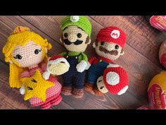 crocheted mario bros amigurt toys sitting on top of a wooden floor