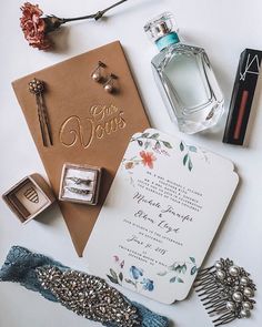 wedding stationery and accessories laid out on top of each other, including an envelope