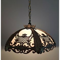 an ornate light fixture hanging from a chain