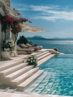 an outdoor swimming pool with steps leading to the water